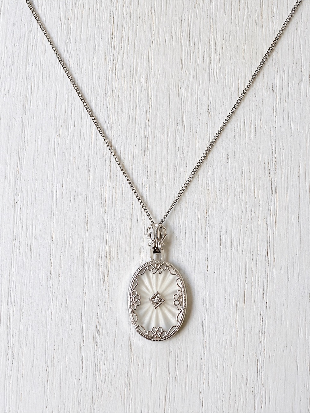 Antique Oval Camphor Glass Pendant with Floral Detail and small crystal center